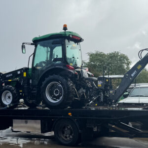 AgKing Tractor on the back of a flat bed truck ready for delivery with backhoe 7 attachment