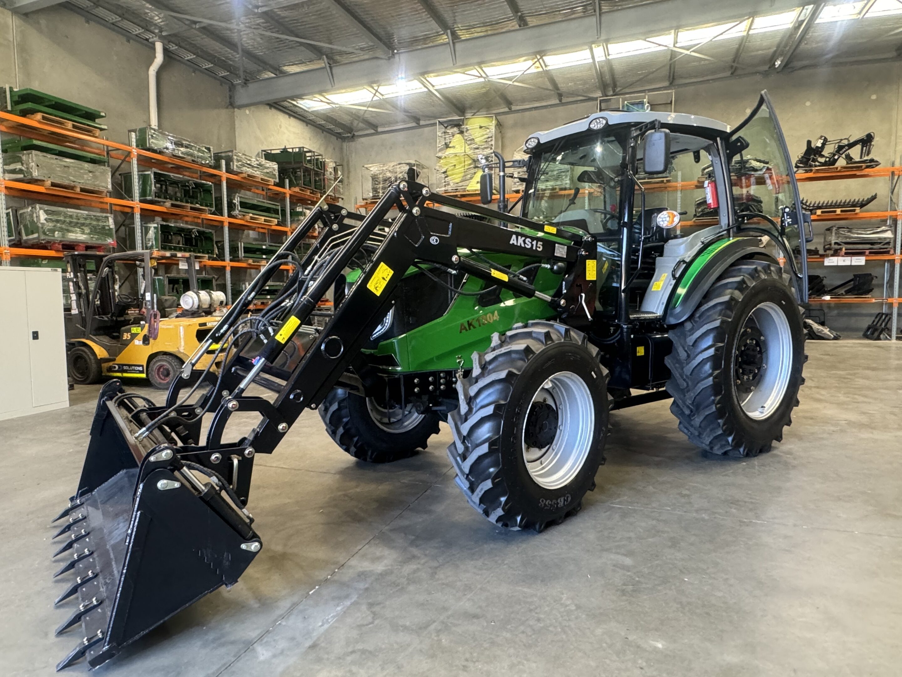 Front angled shot of the AK1304C 130HP tractor in an industrial shed setting