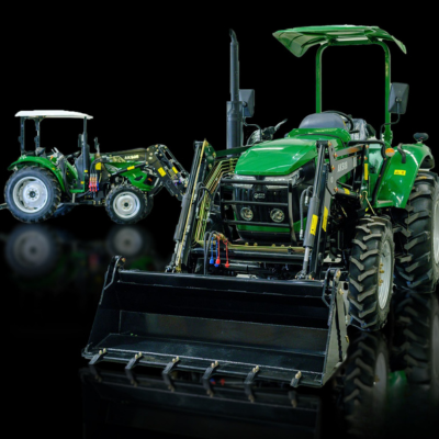 Two AgKing tractors with front-end loaders on display in a black showroom