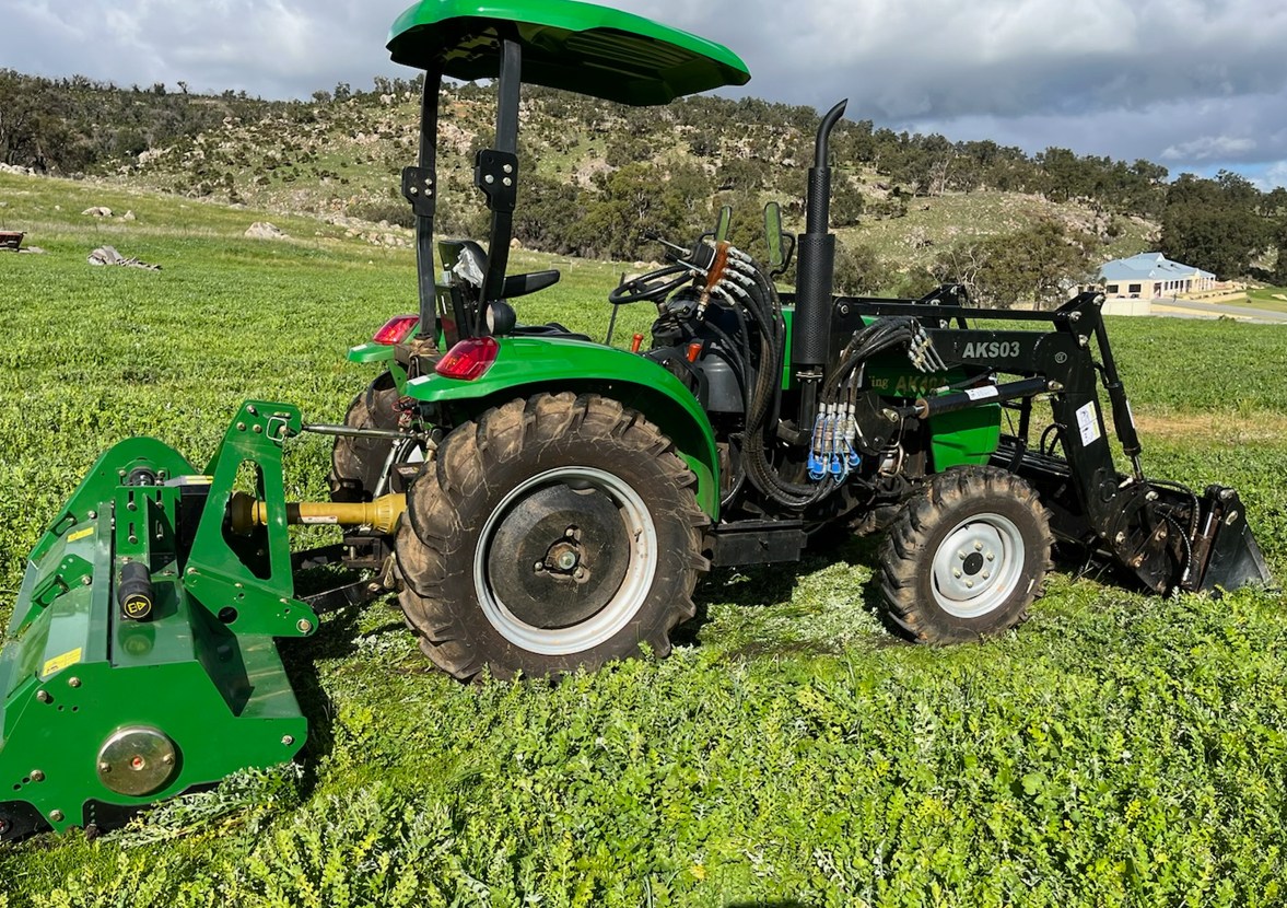 AK404 ROPS tractor with Rotary Hoe at work in a paddock
