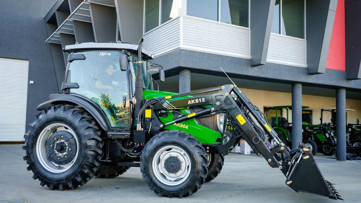 Cabin, ROPS and the safety terms worth knowing AgKing tractor with an AK512 front-end loader attachment, parked outside the AgKing WA dealership with tractors in view.