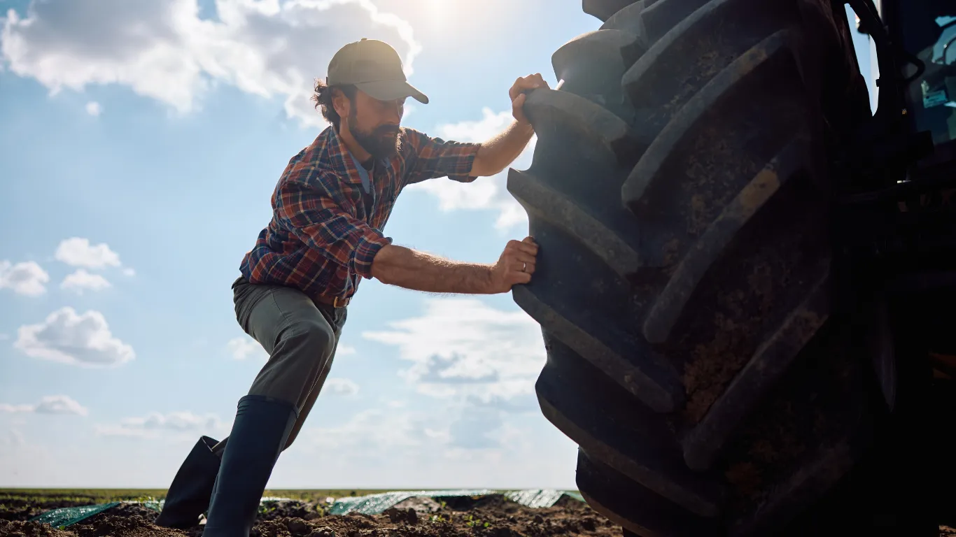  Farmer checking tractor tyres before starting work<br />
